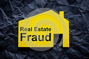 Crumpled black paper and house with inscription Real estate fraud.