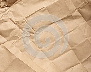 Crumpled blank sheet of brown wrapping kraft paper, vintage texture for the designer