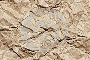 Crumpled brown craft paper texture background. Package wrapping. Old wrapping paper. Baking parchment.