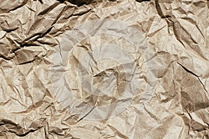 Crumpled brown craft paper texture background. Package wrapping. Old wrapping paper. Baking parchment.