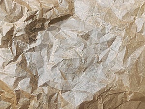 Crumpled brown paper as an interesting background. Abstract paper texture.