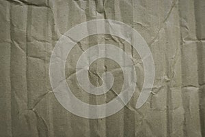 Crumpled of cardboard sheet used as a background. Brown corrugated texture paper