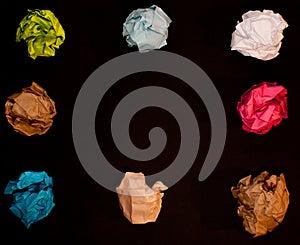 Crumpled colorful paper on black background