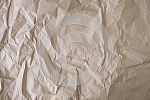 Crumpled craft paper background. Texture of brown crumpled paper, top view.