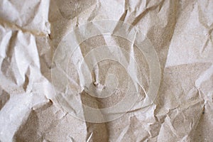 Crumpled craft paper background. Texture of brown crumpled paper, top view.