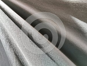 Crumpled dark fabric textured background