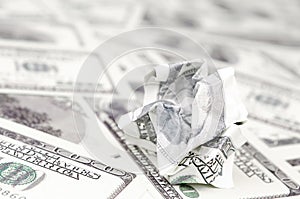 Crumpled dollar bill of the United States lies on the set of smooth money bills