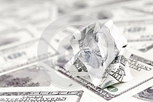 Crumpled dollar bill of the United States lies on the set of smooth money bills