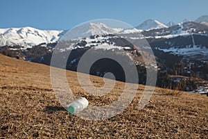 A crumpled empty plastic bottle against the backdrop of the Tian Shan Mountain Range