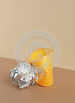 Crumpled empty plastic cup on monochrome background, isometric view, plastic waste, waste recycling, eco friendly  concept