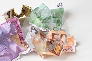 Crumpled euro money. European currency bills of 50, 100, 200 and 500 euros on white background. Selective focus. Money value,