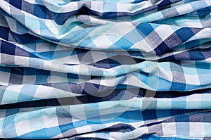 Crumpled fabric with square pattern.