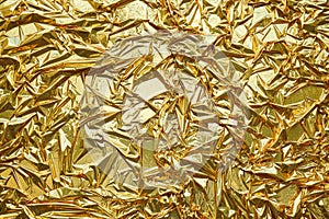 Crumpled, gold metallic foil texture background