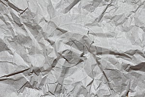 Crumpled gray craft paper texture background. Package wrapping. Old wrapping paper. Baking parchment.