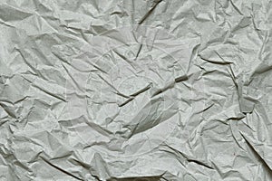 Crumpled gray craft paper texture background. Package wrapping. Old wrapping paper. Baking parchment.