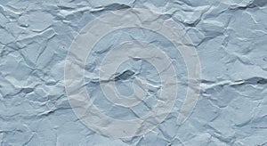 Crumpled gray paper with a rough texture and uneven surface features. The folds and