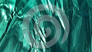 Crumpled green foil. Metallized wrinkled surface