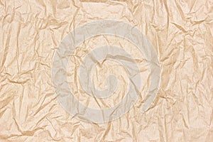 Crumpled kraft packing paper texture. Recycled brown paper sheet. Abstract background