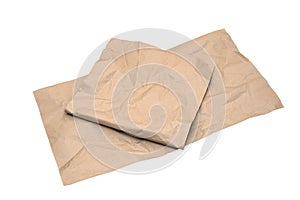 Crumpled kraft wrapping paper sheets isolated on white background. Packaging and recycled materials concept. Copy space