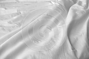Crumpled messy white blanket untidy, Unmade bed sheet after waking up in the morning texture