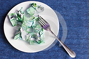 Crumpled money on a plate,