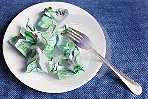 Crumpled money on a plate