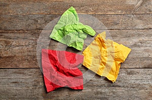 Crumpled napkins on wooden background, top view.