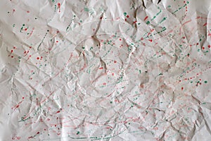 Crumpled paper bacckground with paint splashes