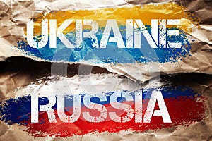 Crumpled paper background with a Russian and Ukraine flags. Concept of world crisis and war