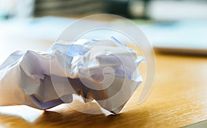 Crumpled paper ball on office desk