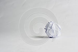 Crumpled paper ball on the white background.