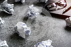 Crumpled paper balls with notebook on desk office, Creativity problems