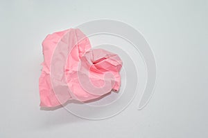 Crumpled paper in the shape of heart on a white background. The concept of love, friendship and parting. Space for text.