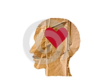 Crumpled paper shaped as a human head and heart on white.