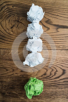 Crumpled paper symbolizing different solutions forming an exclamation-mark