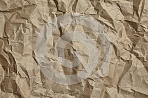 Crumpled paper, texture, background. Brown craft paper with wrinkled pattern