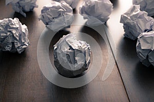 crumpled paper on wood background. Business frustrations, Job st photo