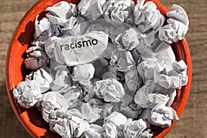 Crumpled paper written racismo, portuguese and spanish word for photo