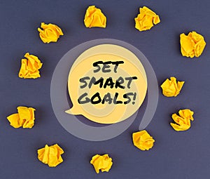 Among the crumpled pieces of paper lies a sticker sheet with the inscription - SET SMART GOALS