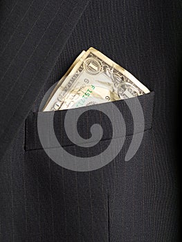 Crumpled shabby one dollar banknote in a chest pocket of business suit