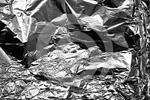 Crumpled sheet of aluminum shiny foil.