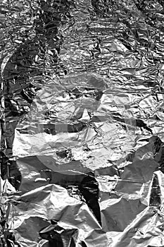 Crumpled sheet of aluminum shiny foil.