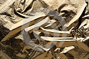 Crumpled sheet of gold. abstract relief material