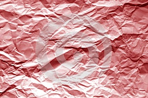 Crumpled sheet of paper with blur effect in red tone