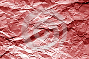 Crumpled sheet of paper in red color