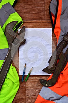 A crumpled sheet of paper with two pencils surrounded by green a