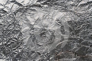 Crumpled and shiny silver paper background. Crumpled foil texture