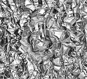 Crumpled silver foil texture. Shiny festive background. Metallized paper.