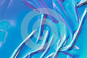 Crumpled turquoise foil on white background, top view