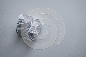 Crumpled up thoughts on a sheet of paper. trashed discarded